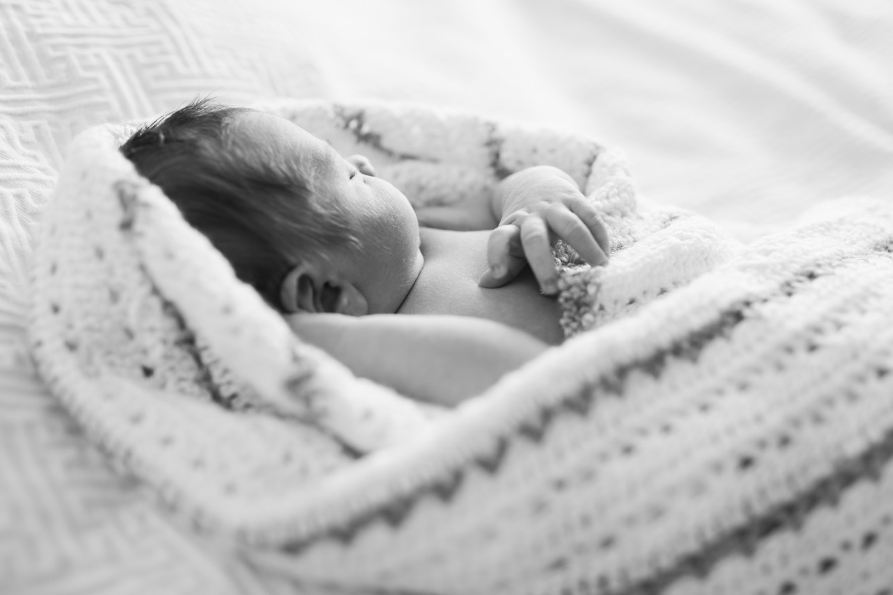 Newborn lifestyle session - black and white image of newborn baby