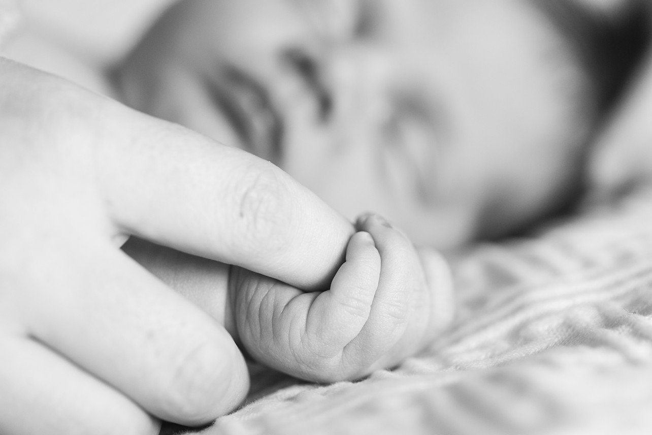 Newborn lifestyle session - newborn is holding his mama's finger