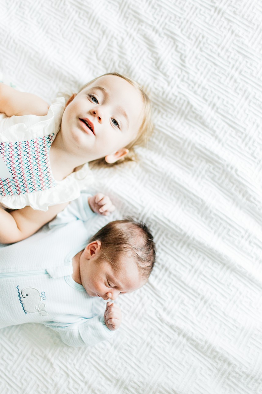 Newborn lifestyle session - vertical image of a girl and her baby brother