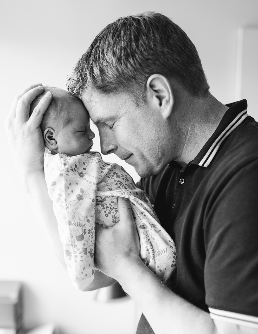 Home Newborn Session Discovery Bay HK - dad and newborn baby forehead to forehead in black and white