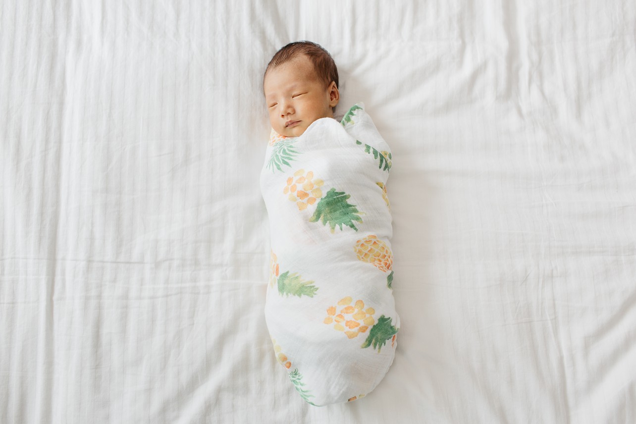 Newborn Session in Happy Valley with William - baby on the bed with a pineapple swaddle