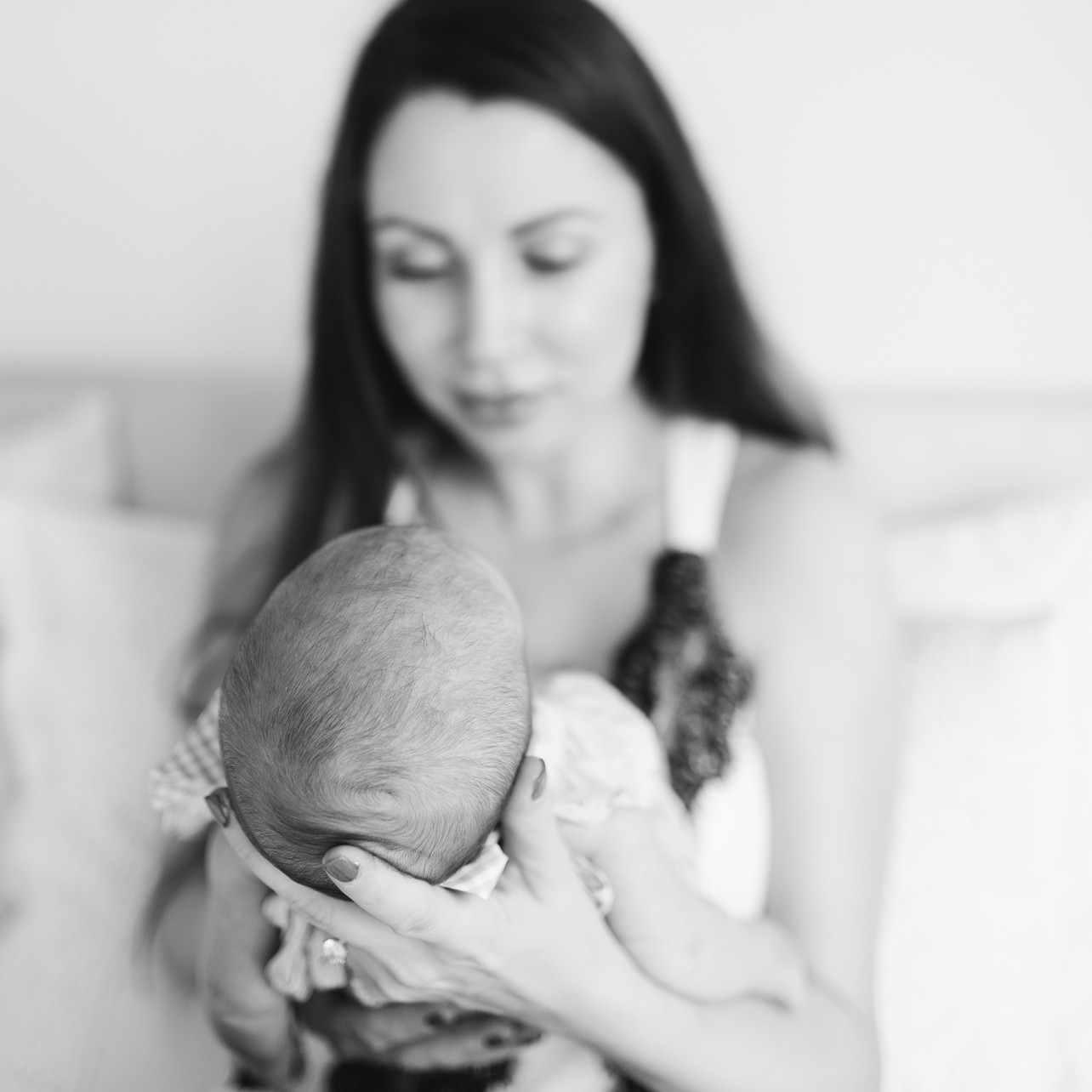 Tung Chung Newborn Session - mom is holding a baby in black and white
