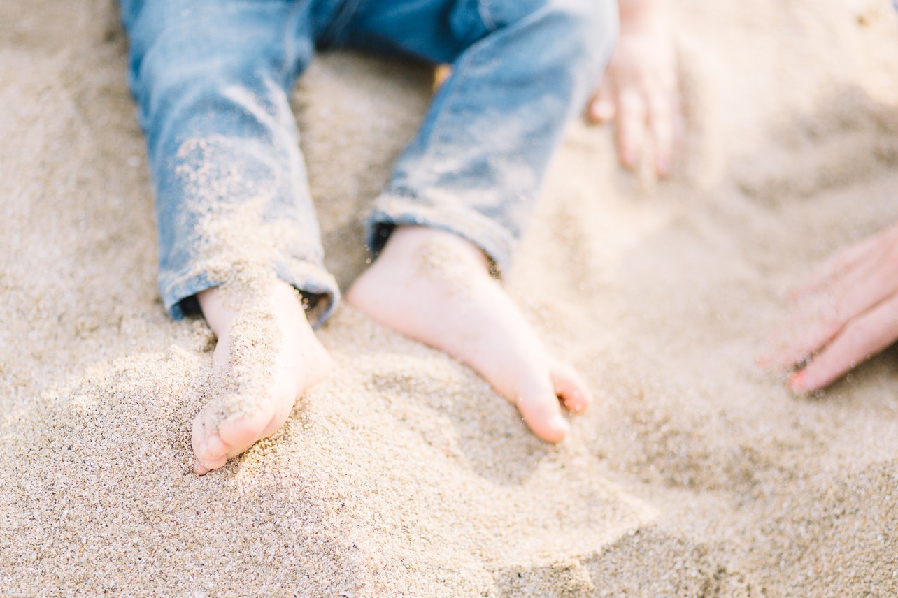 Best time to have your outdoor session - toddlers feet are in the sand on the beach