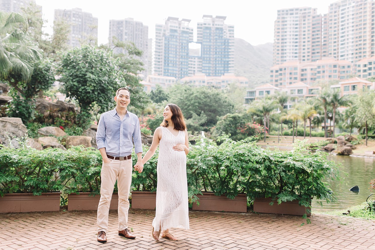 Central Park Maternity Session in Discovery Bay - mama is holding dad's hand and smiling at him