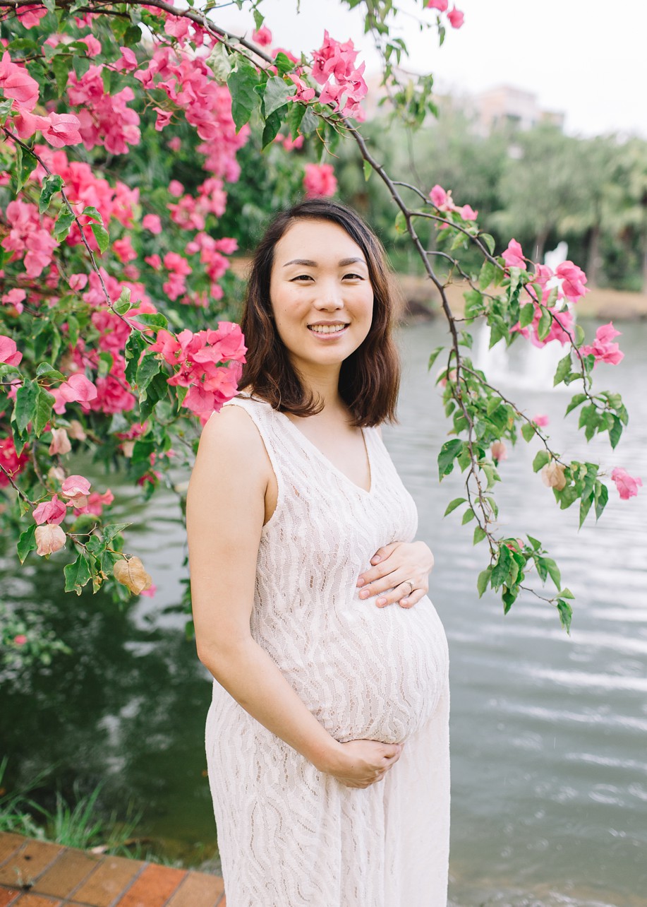 Central Park Maternity Session in Discovery Bay - pregnant mother smiling with the pink flower