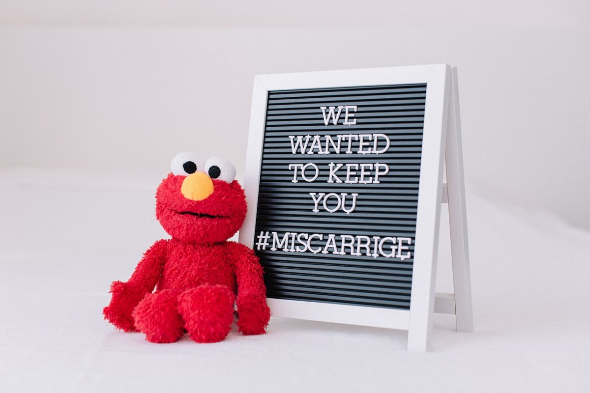 word board saying we wanted to keep you with Elmo doll