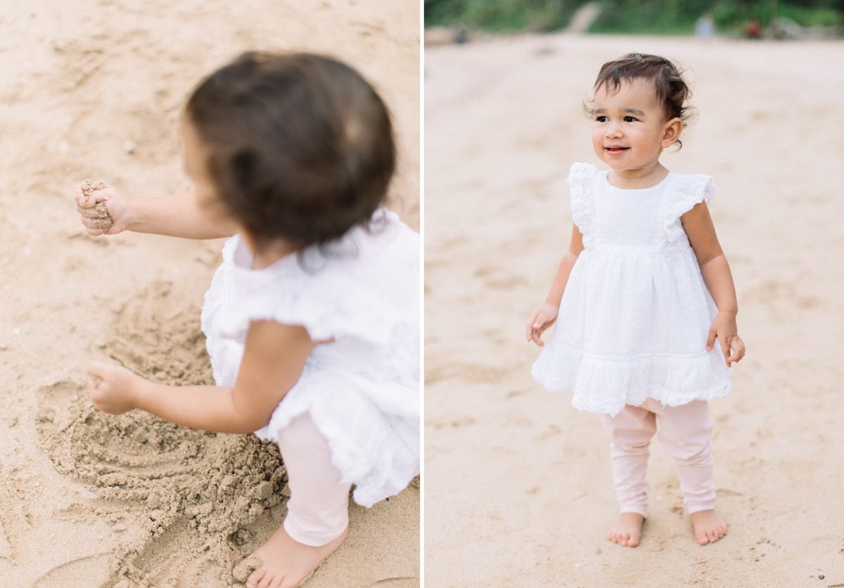 girl in the white dress is playing with sand
