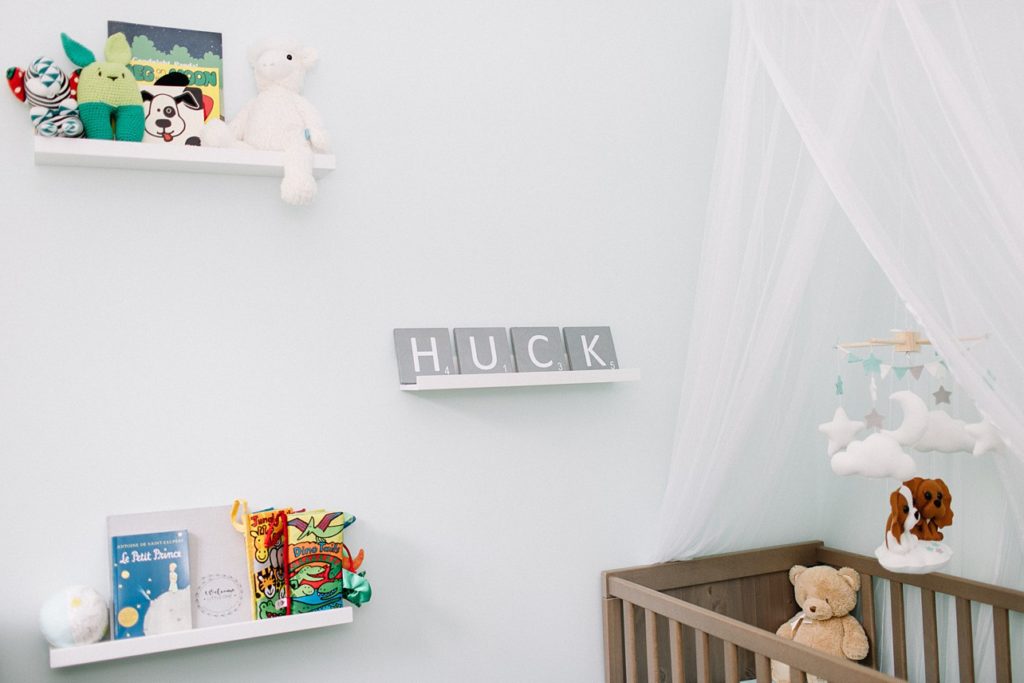 wall decoration for baby Huck's room with lots of books and stuffed animals