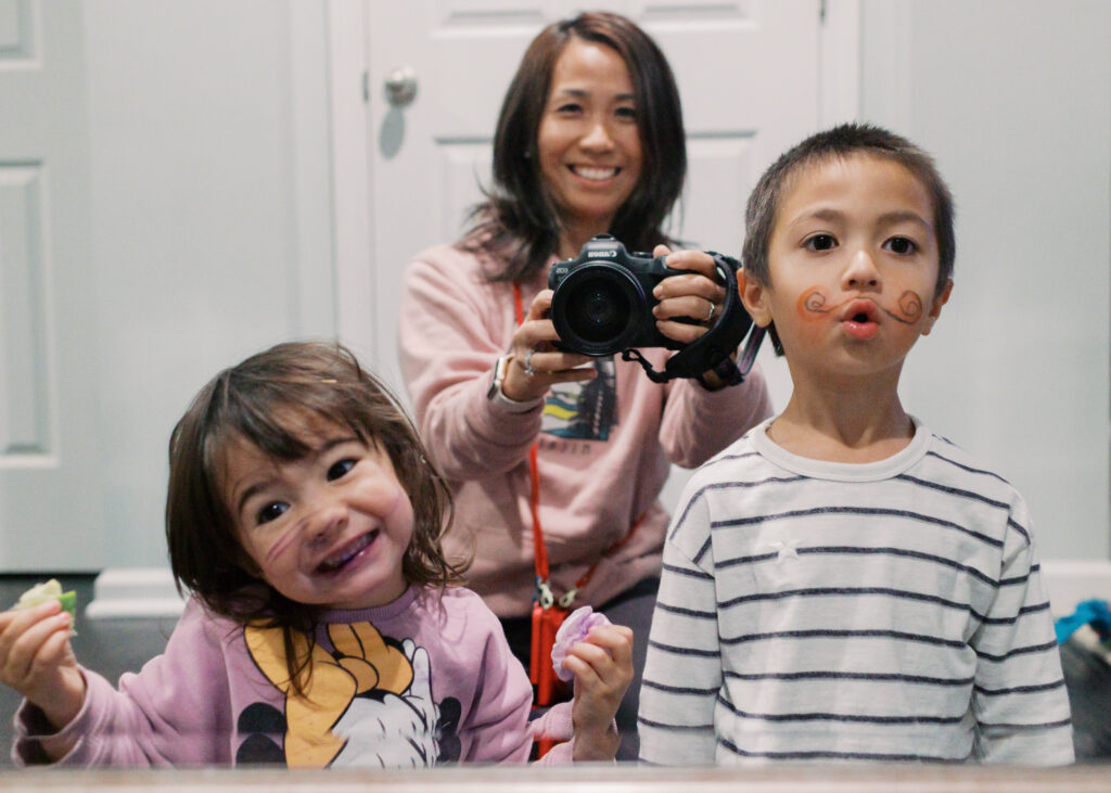 Selfie of Mai and children making funny faces in the mirror