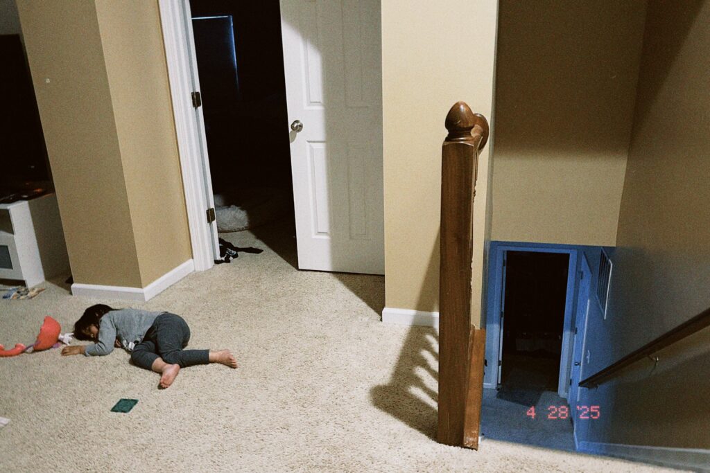 Daughter lying in the hallway.